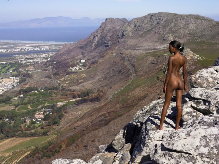 Naked girl at the top of the mountain