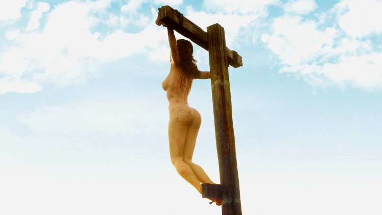 BDSM crucified at a height in the forest