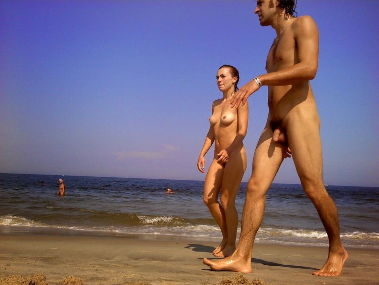 Naked men and women on a nudist beach