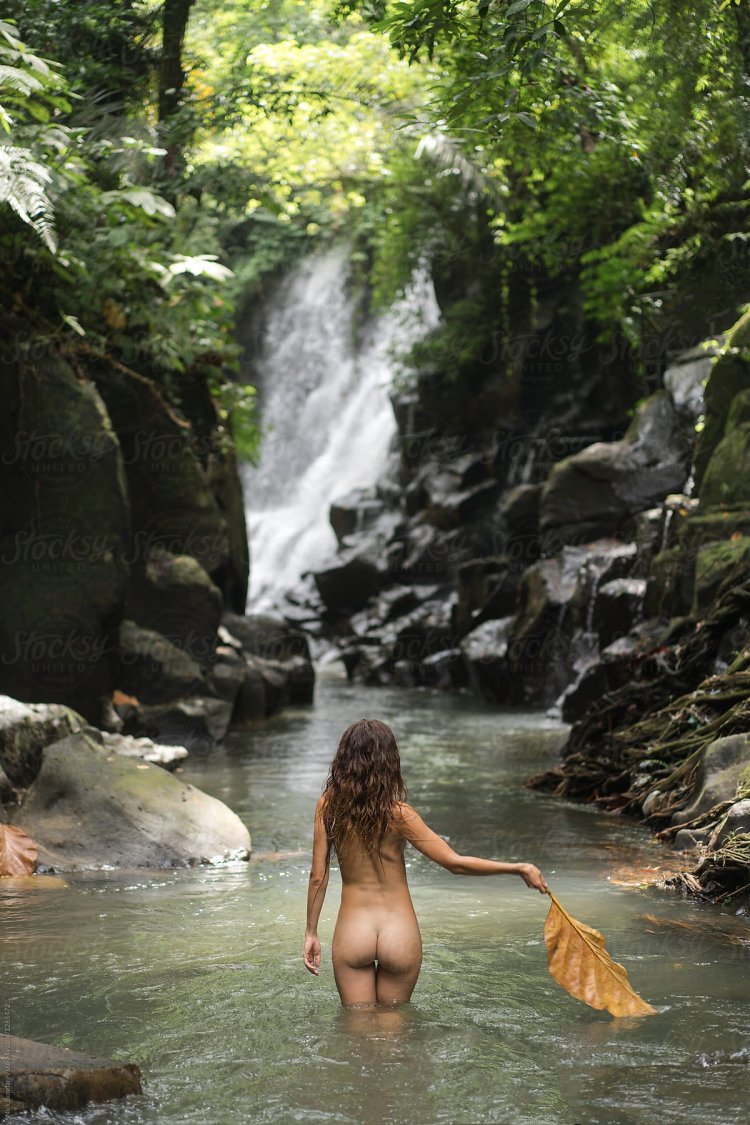 Naked women bathe in the river