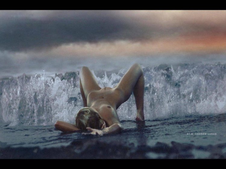 Naked woman lies on the river