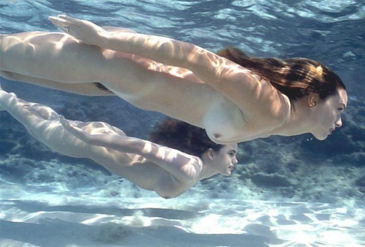Naked women swim in the sea