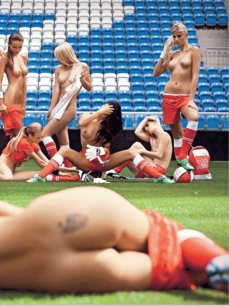 The girl undresses on the football field