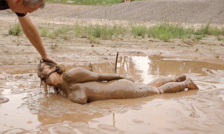 Girls are lying in the mud