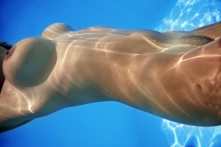 Submarine swimming of a woman nude