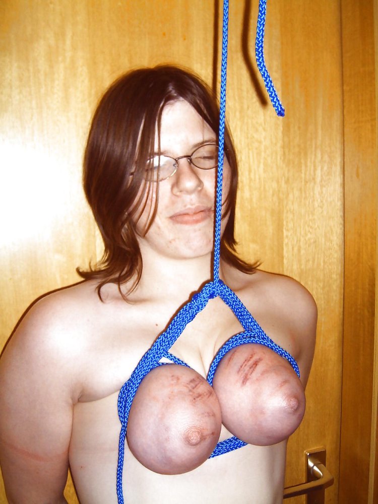 Naked women suspended by the legs