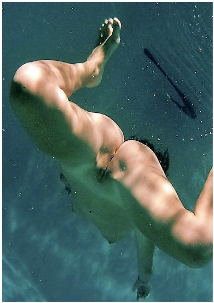 Naked woman floats in water