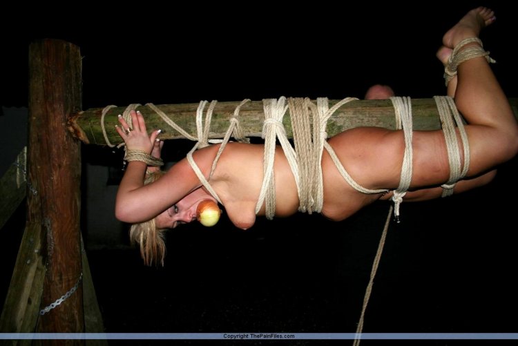 Girls tied to a stick