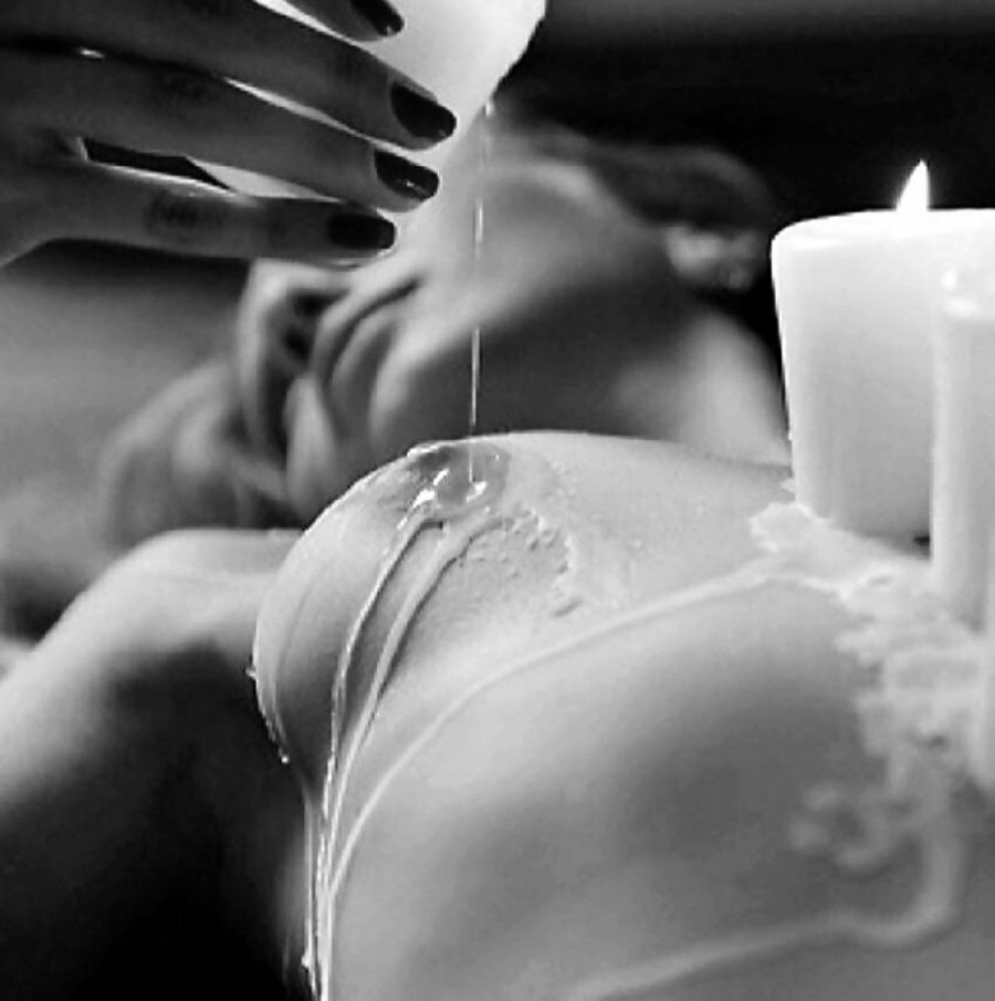Hot wax on the body of a bdsm